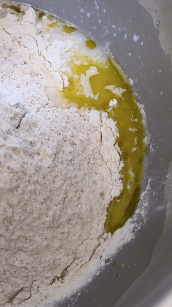 Ingredients for sourdough pita in a mixing bowl